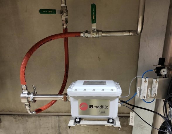 Installation of an IRmadillo instrument into the outlet stream from the mill's weak black liquor tank, using a flow cell for continuous process measurement.